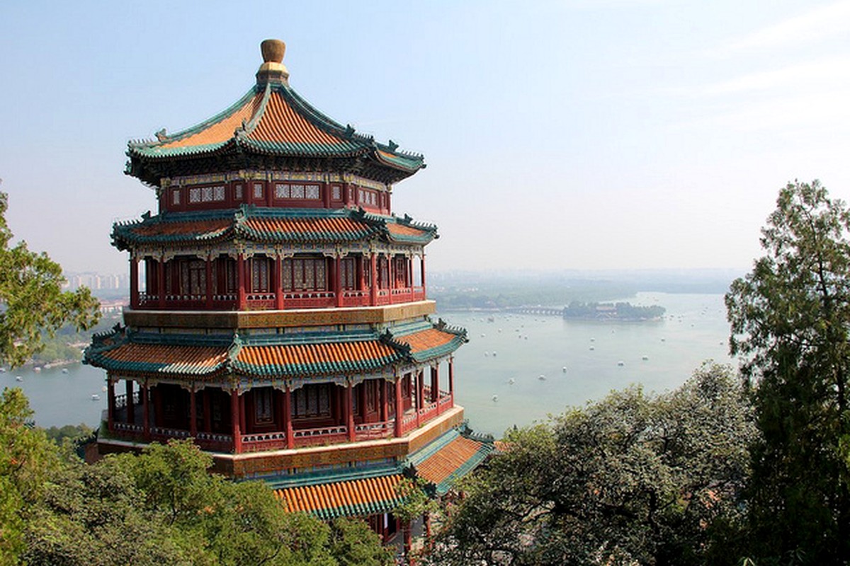 A traditional pavilion overlooking water and surrounding greenery.